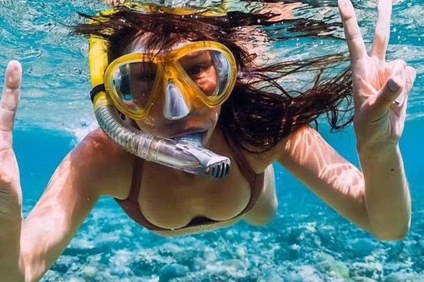 A person snorkeling underwater with a snorkel and mask. 4