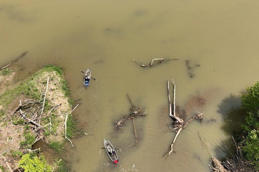 A river with boats and driftwood. 3