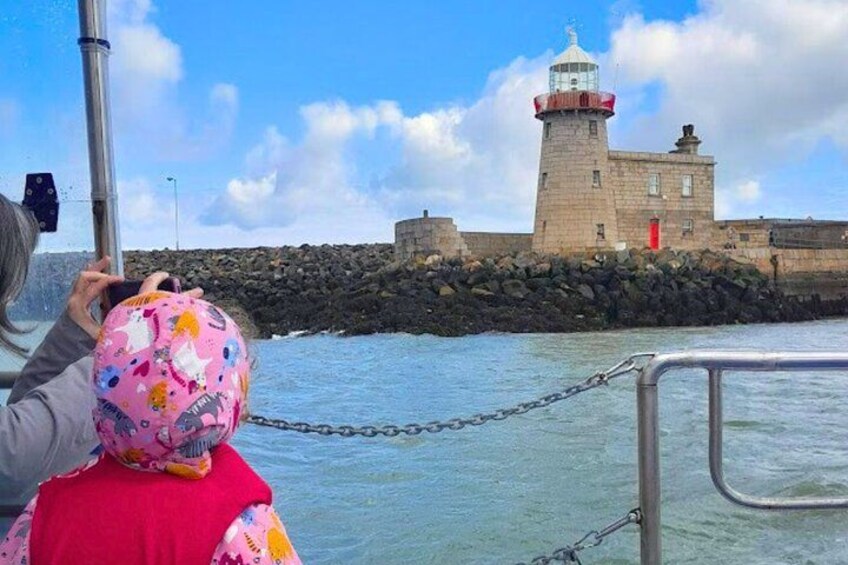 A lighthouse, rocky shoreline, and calm water. 3