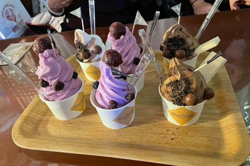 Tres vasos de helado con ingredientes adicionales sobre una bandeja de madera. 1