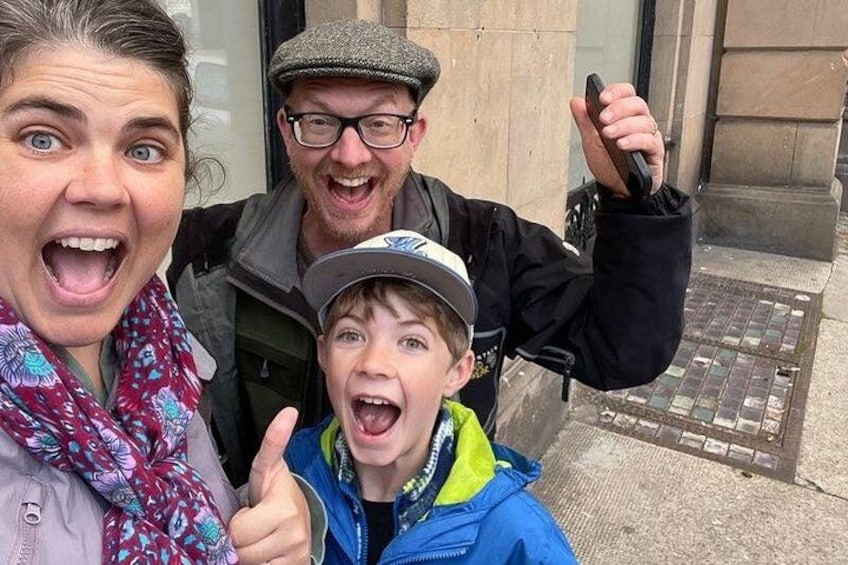 A person in a black jacket and cap, another in a blue jacket, and a child giving a thumbs-up. 3