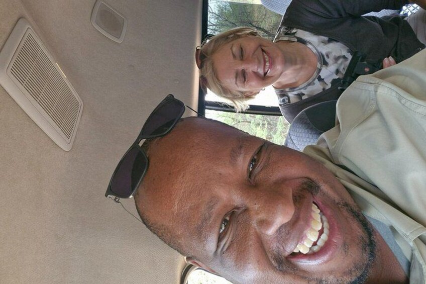 A vehicle interior with a person wearing sunglasses and a seatbelt. 4