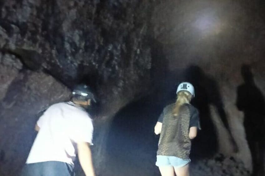 Two people exploring a cave. 4