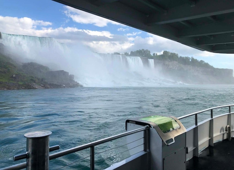 A boat with a view of a large waterfall. 3