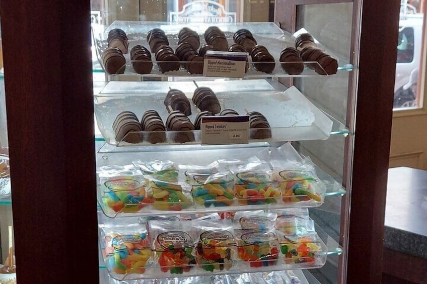 A display case with various packaged snacks and chocolates. 2