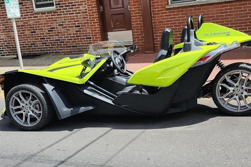 A yellow and black motorcycle parked on a street. 1