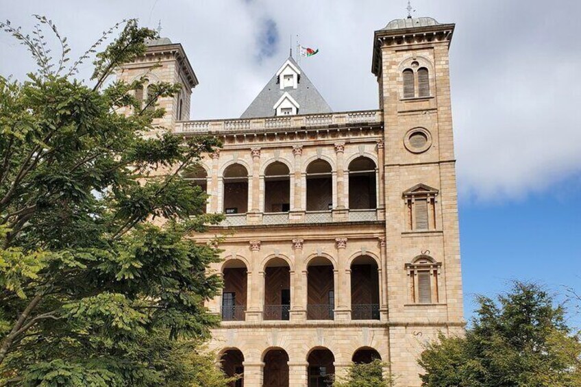A historic building with arched windows and a clock tower. 1