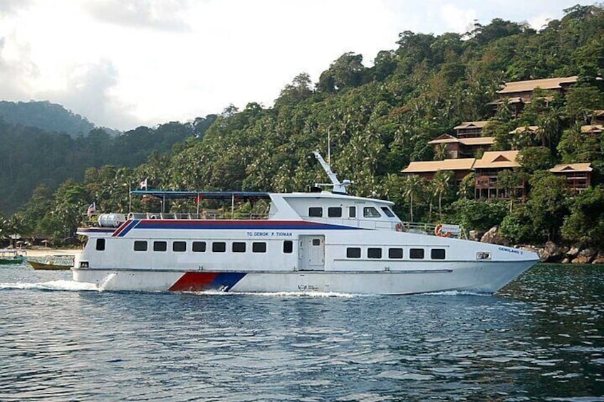 A white boat with blue and red stripes on a calm body of water, surrounded by lush greenery and hills. 2