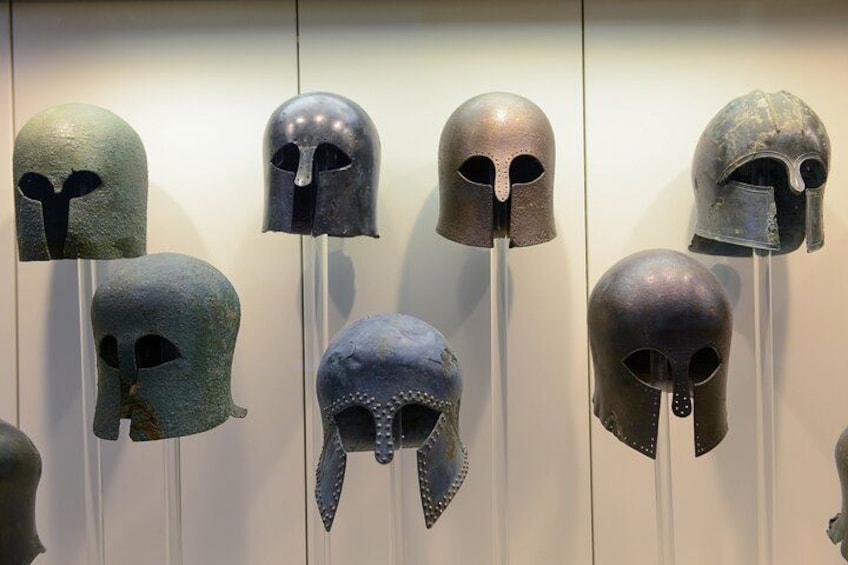 A collection of ancient helmets on display. 2
