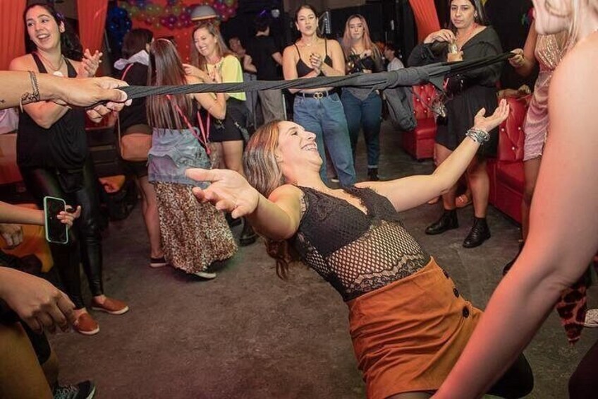 A person being pulled by a rope in a crowded indoor setting. 3