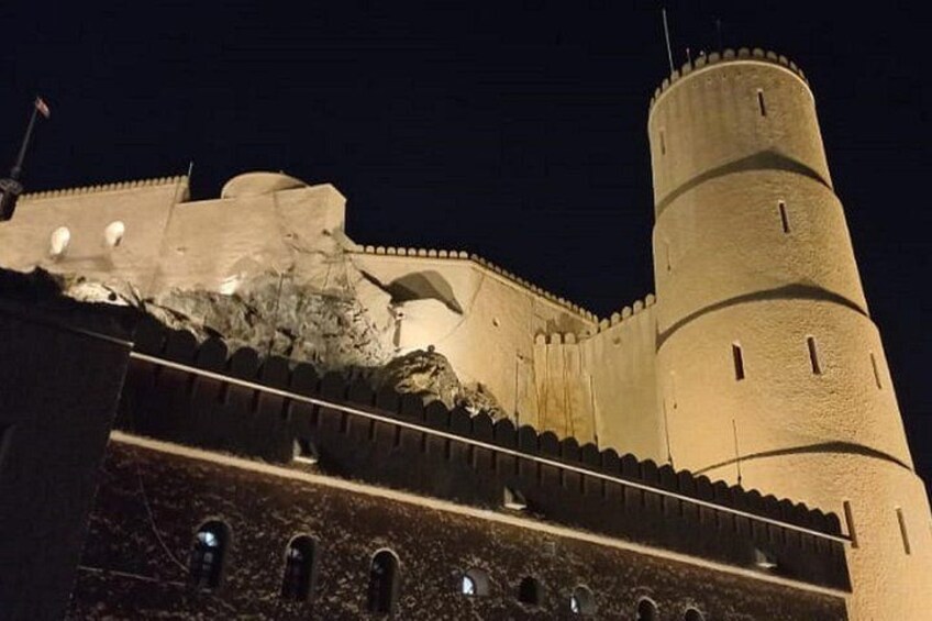 A historic fortress with a prominent tower and a fortified wall. 1