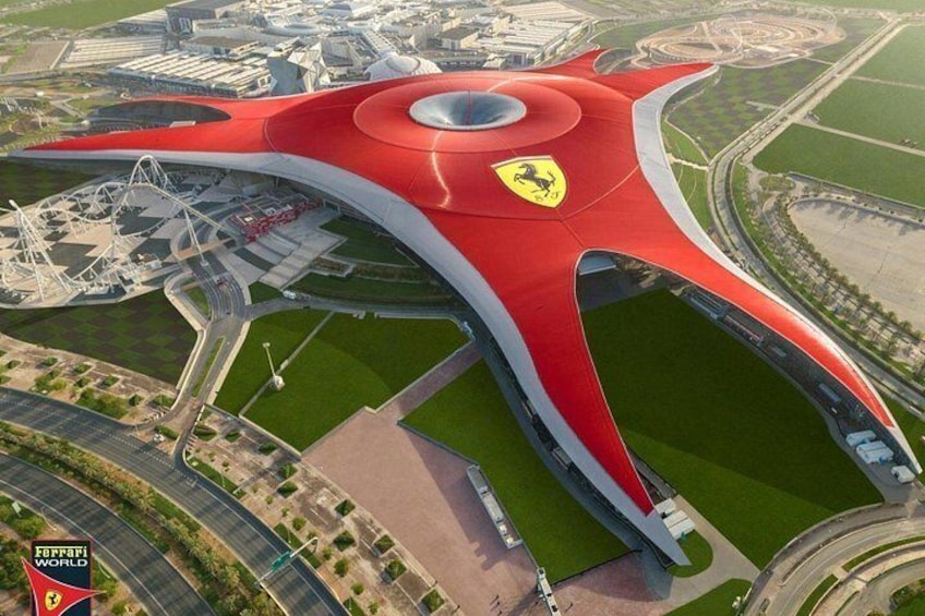 A modern stadium with a distinctive red roof and a Ferrari logo. 2