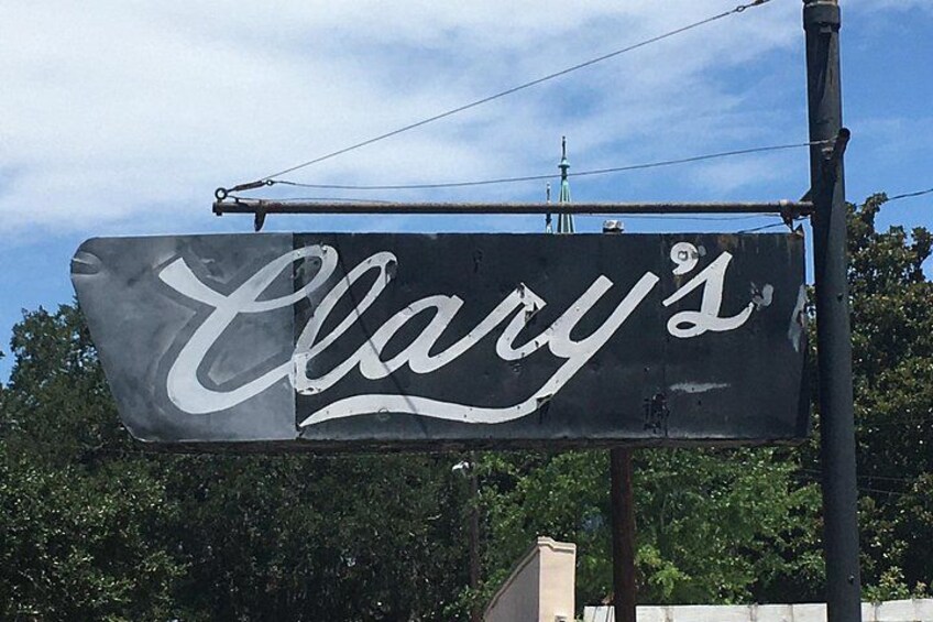 A sign with the word 'Clary's' in cursive font. 2