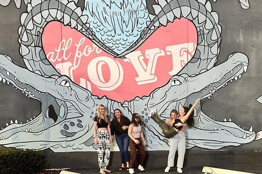 A mural with a crocodile and a heart with the words 'all for LOVE' on a wall. 2