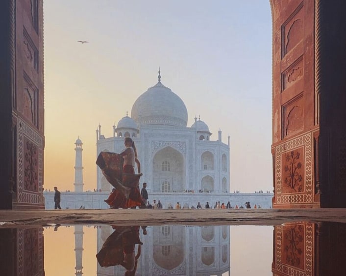 The Taj Mahal with its reflection in a body of water, surrounded by minarets and intricate architectural details. 5