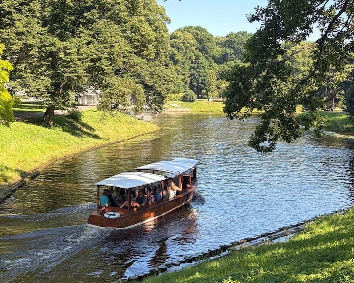 Un bateau transportant des passagers sur une rivière bordée d’arbres. 1