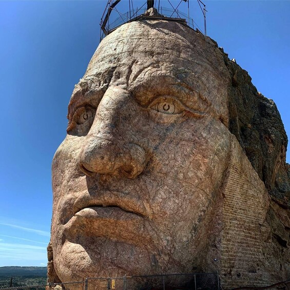 A large rock face with a carved face. 1