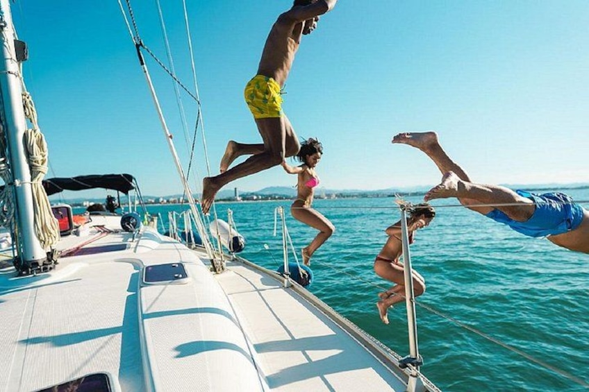 People jumping off a boat into the water. 1