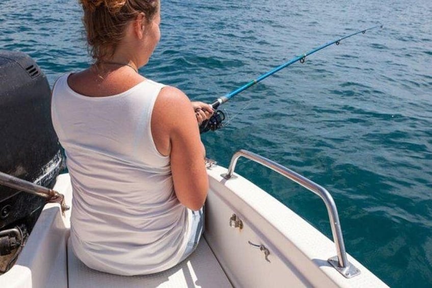 A person fishing on a boat. 5