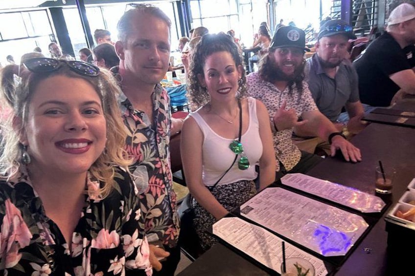 A group of people seated at a table with menus in a restaurant. 5