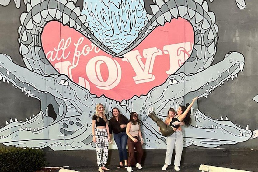 A mural with a crocodile and a heart with the words 'all for LOVE' on a wall. 2