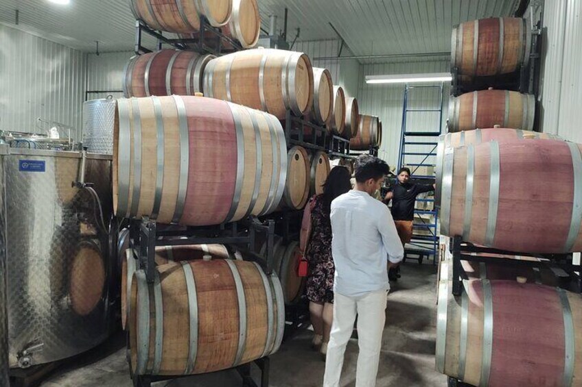 Large wooden barrels stacked in a warehouse. 2