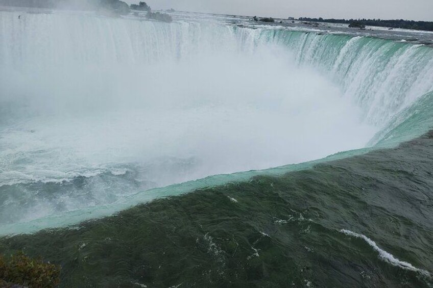 A large waterfall with a wide, turbulent water flow. 5