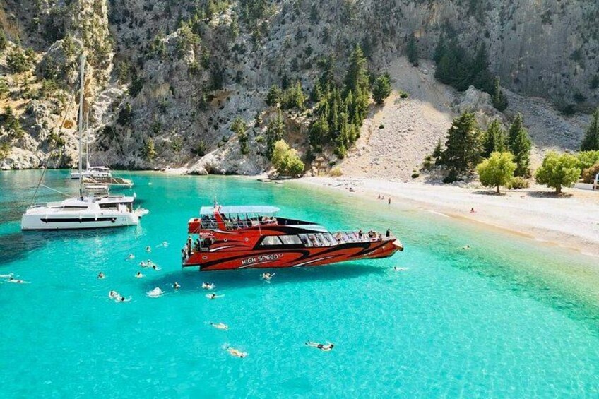 A red speedboat named 'High Speed' on turquoise waters with a rocky coastline and a sailboat in the background. 3