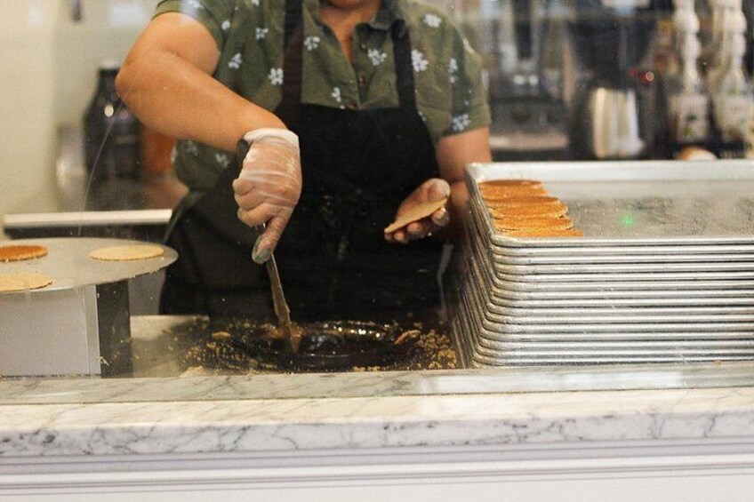 A person cooking pancakes on a griddle. 5