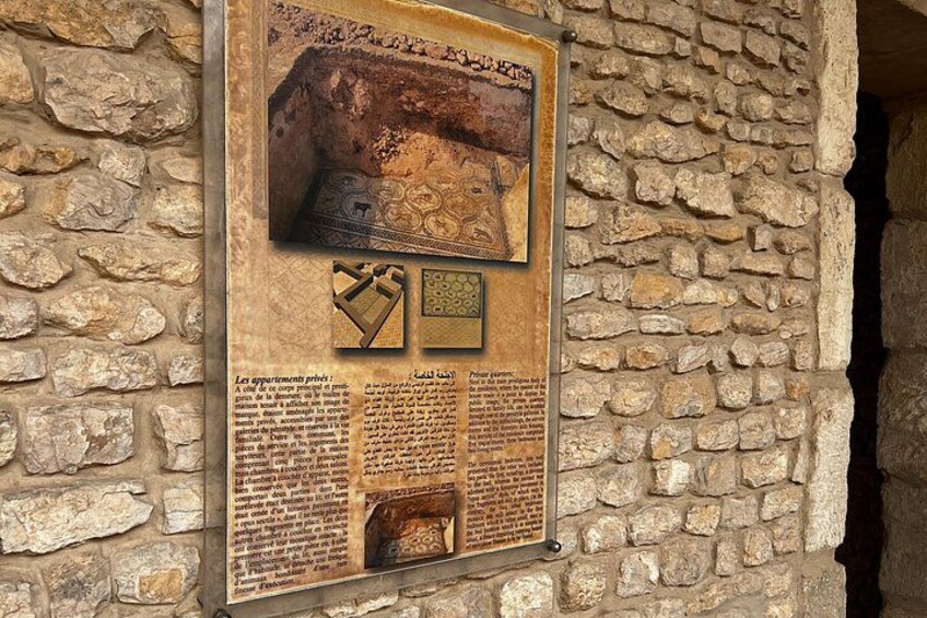 A stone wall with a mounted informational plaque. 3