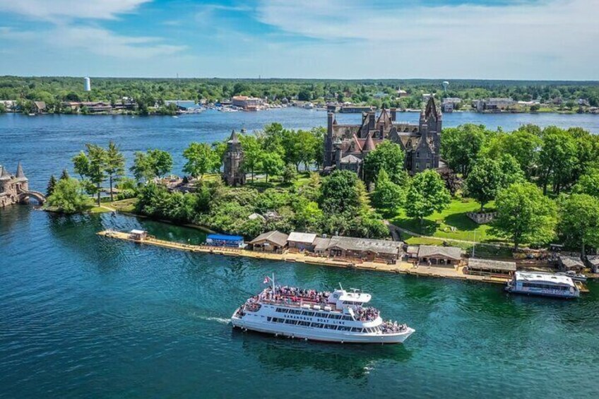 A river with a cruise ship, a castle, and a dock with boats. 1