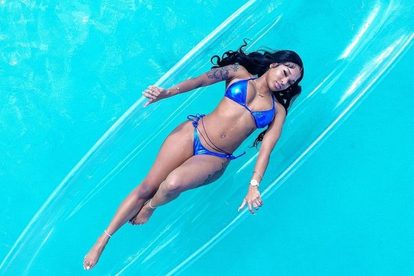 A person floating on a clear blue surface. 5