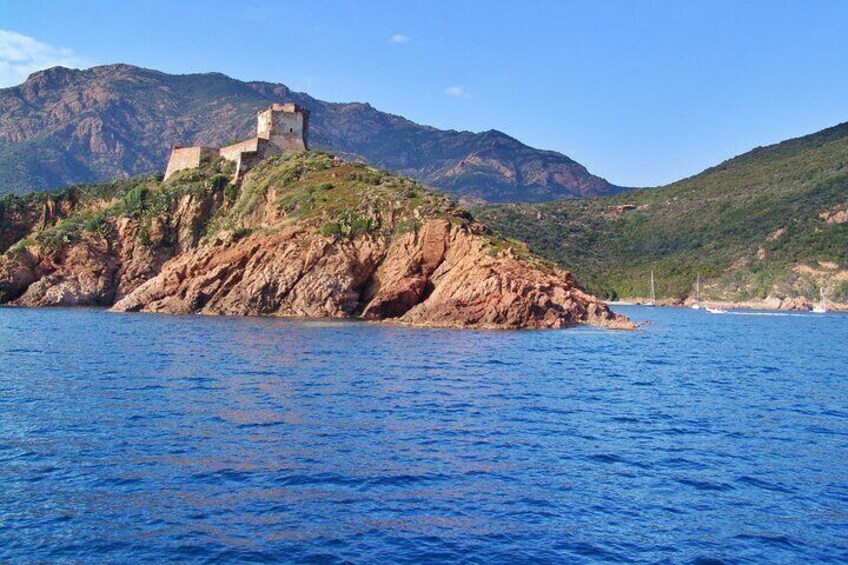A coastal landscape with a rocky island featuring a historical building. 2