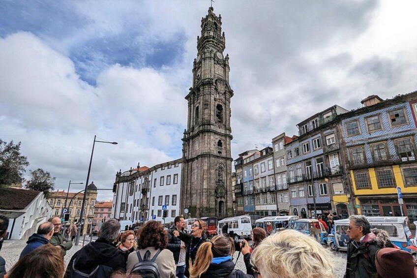 Una torre histórica, una multitud de personas y edificios coloridos. 2
