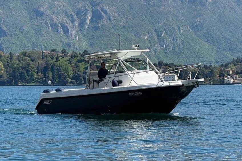 A boat on a lake with mountains in the background. 4