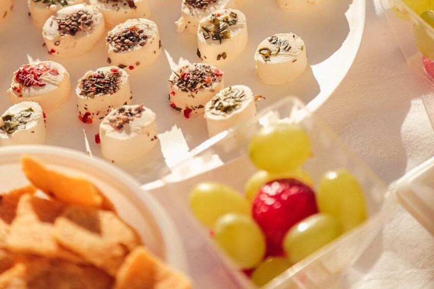 A variety of food items including cheese, grapes, and a pastry. 5