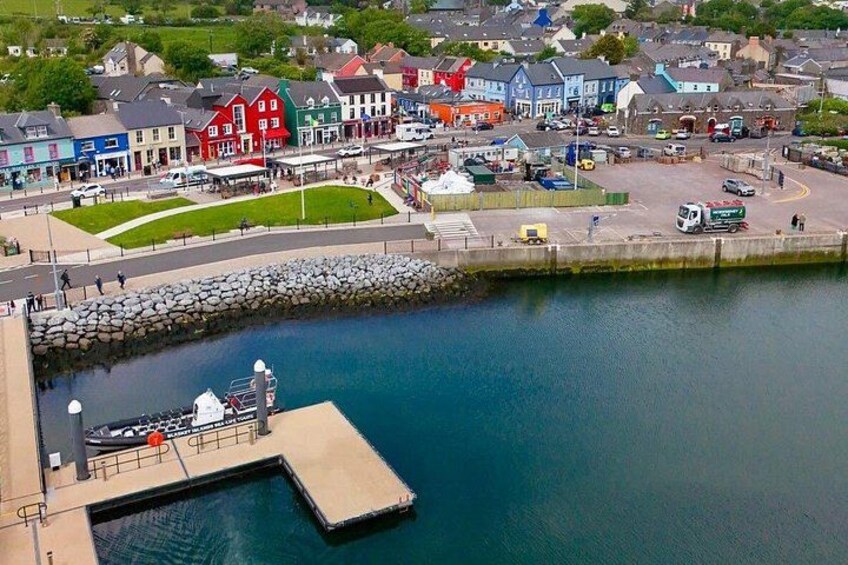 A coastal town with a dock, colorful buildings, and a calm harbor. 4