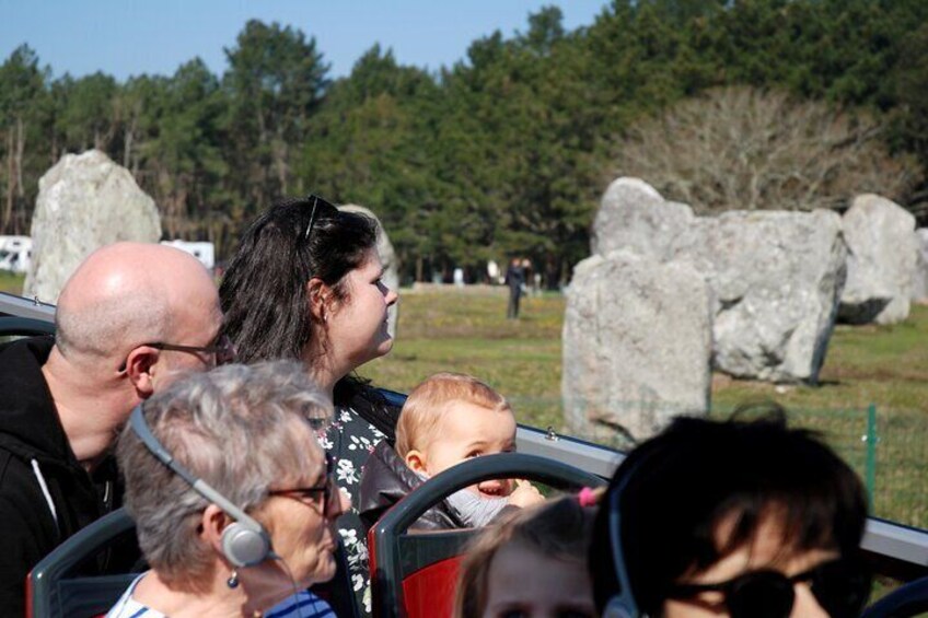 A group of people on a roller coaster with large rocks in the background. 5