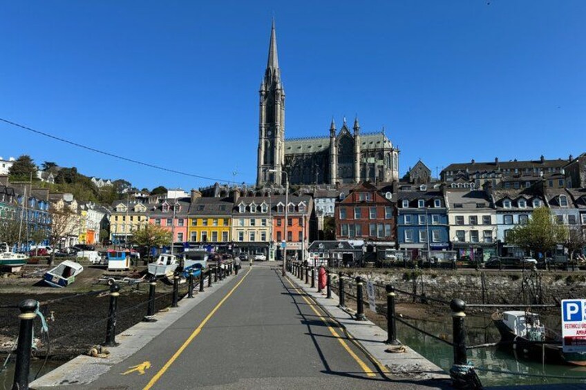 A bridge leading to a historic cathedral, colorful buildings, and a river. 3