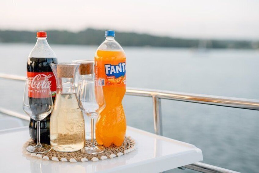 A table with beverages and a glass on a boat. 3