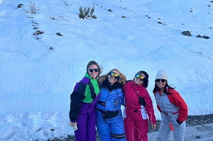A group of people in winter clothing on a snowy slope. 3