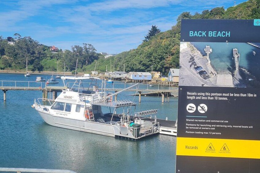 A boat docked at a pier with a sign indicating a maximum length of 10 meters and a maximum weight of 10 tonnes. 4
