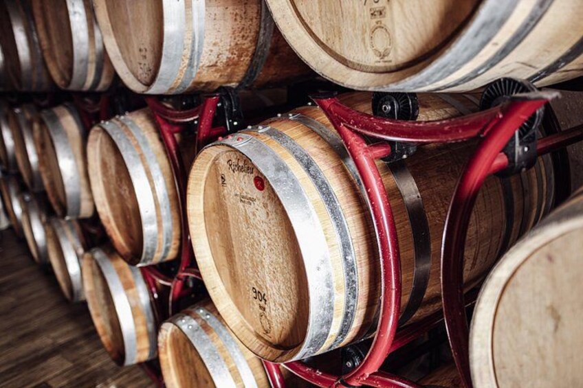 Wooden barrels stacked in a warehouse. 4