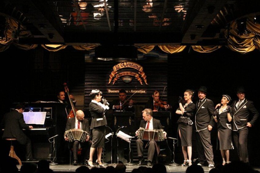 A band performing on stage with a sign reading 'La Gendarme' in the background. 4