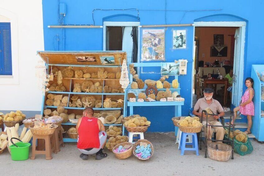 A street vendor stall with various goods displayed on shelves and tables. 3