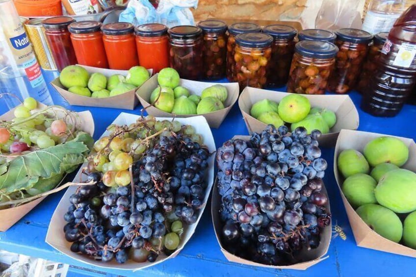 Various fruits and jars on a table. 2