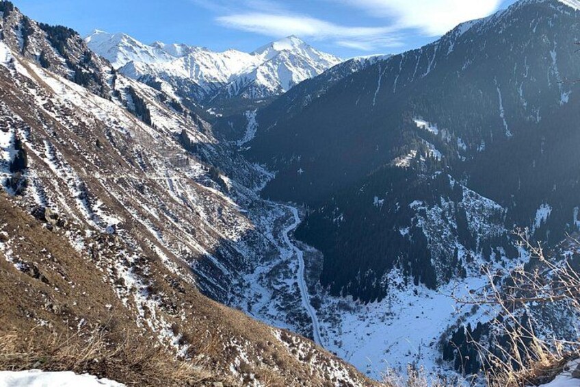 A mountainous landscape with snow-covered slopes and a valley. 4