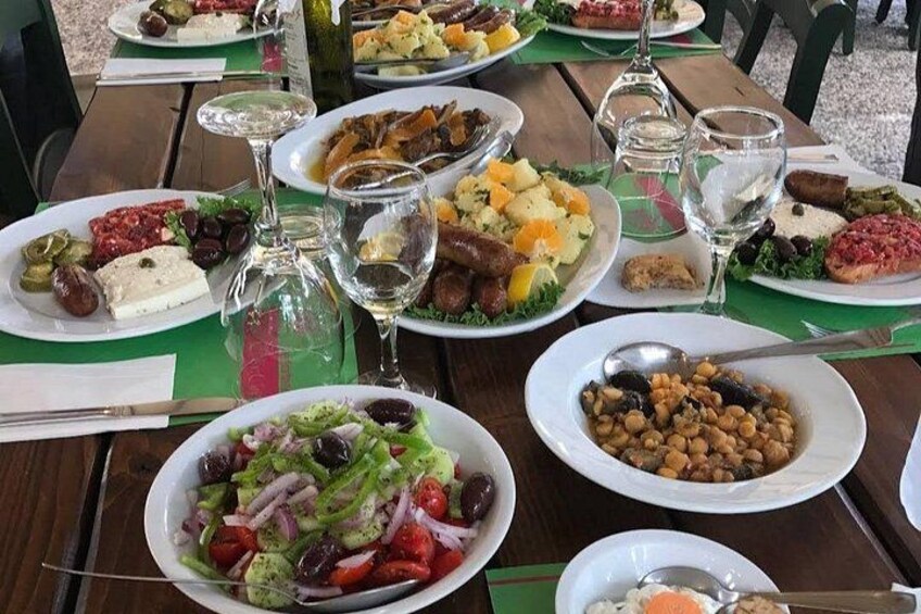 A table set with various dishes, wine glasses, and a bottle. 4