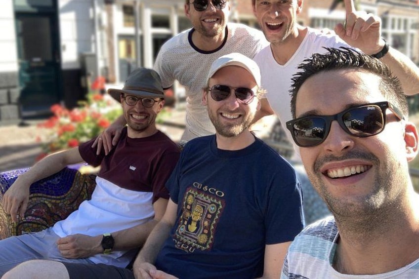 A group of people sitting on a bench outdoors. 2