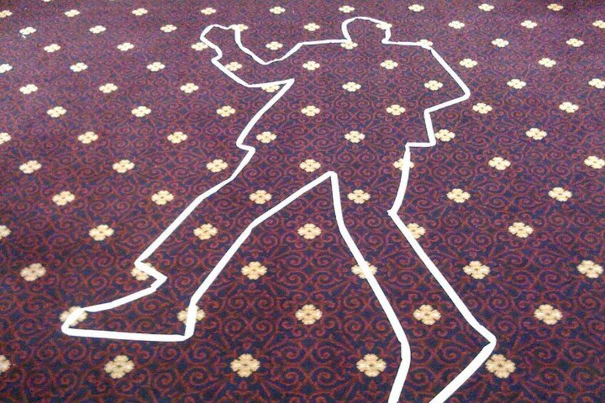 A patterned carpet with a white line drawing of a person. 5